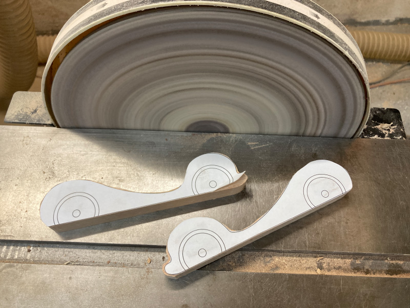 Photo of cut pieces next to a disc sander